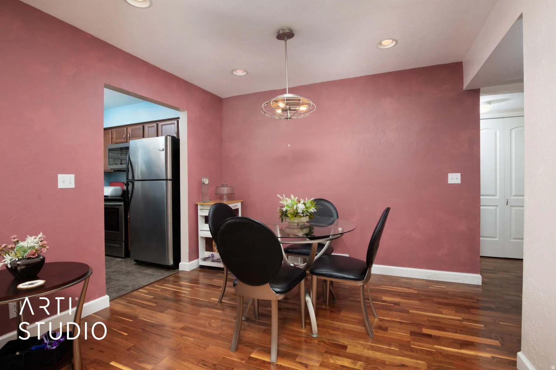 Dining area featuring wood-finish flooring, recessed lighting, and a modern ceiling fixture