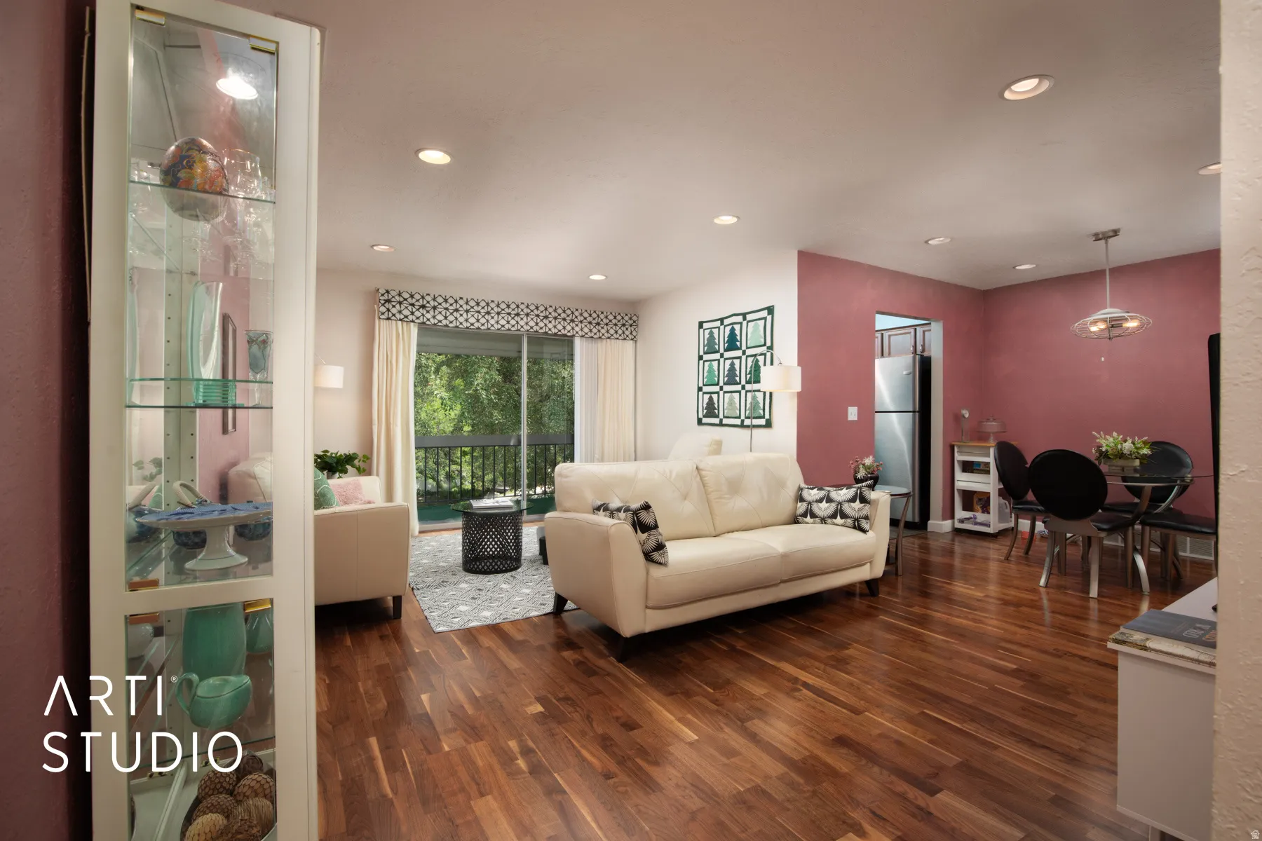 Wood-finish flooring, recessed lighting, built-in display cabinet, and a sliding glass door to a balcony