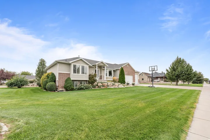 Two-story exterior with a brick and stucco facade, a side-entry garage, and a concrete driveway