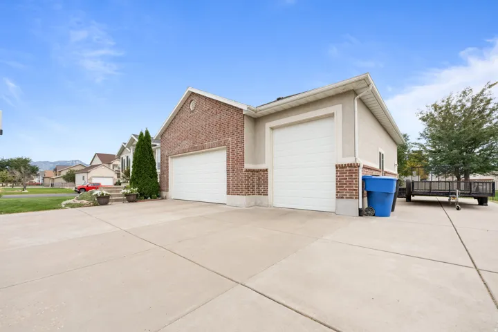 Brick and stucco exterior with two garage doors
