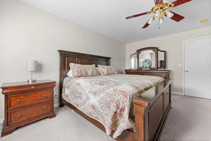 Primary Bedroom, wall-to-wall carpeting and a ceiling fan with integrated lighting