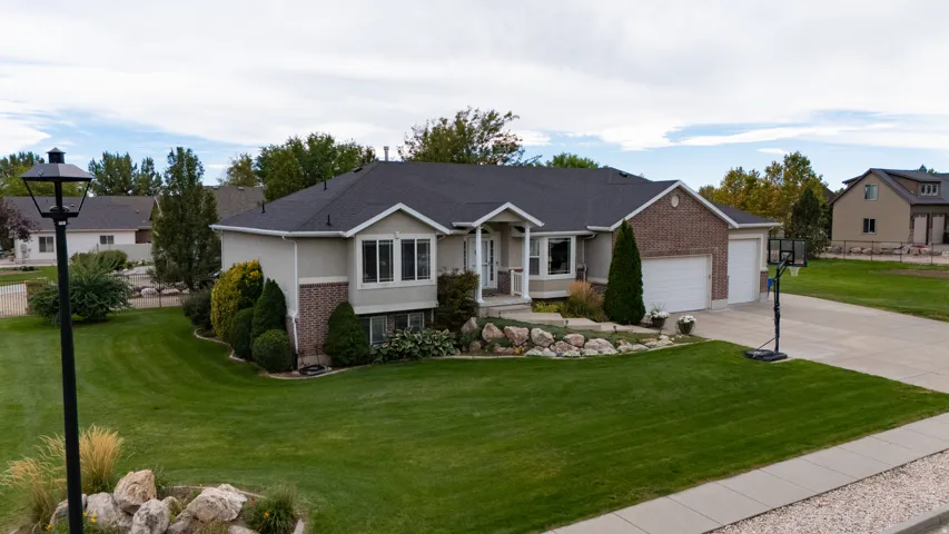 Brick and siding exterior with a dark shingle roof