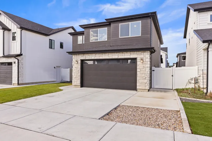 Modern exterior featuring stone veneer and dark siding