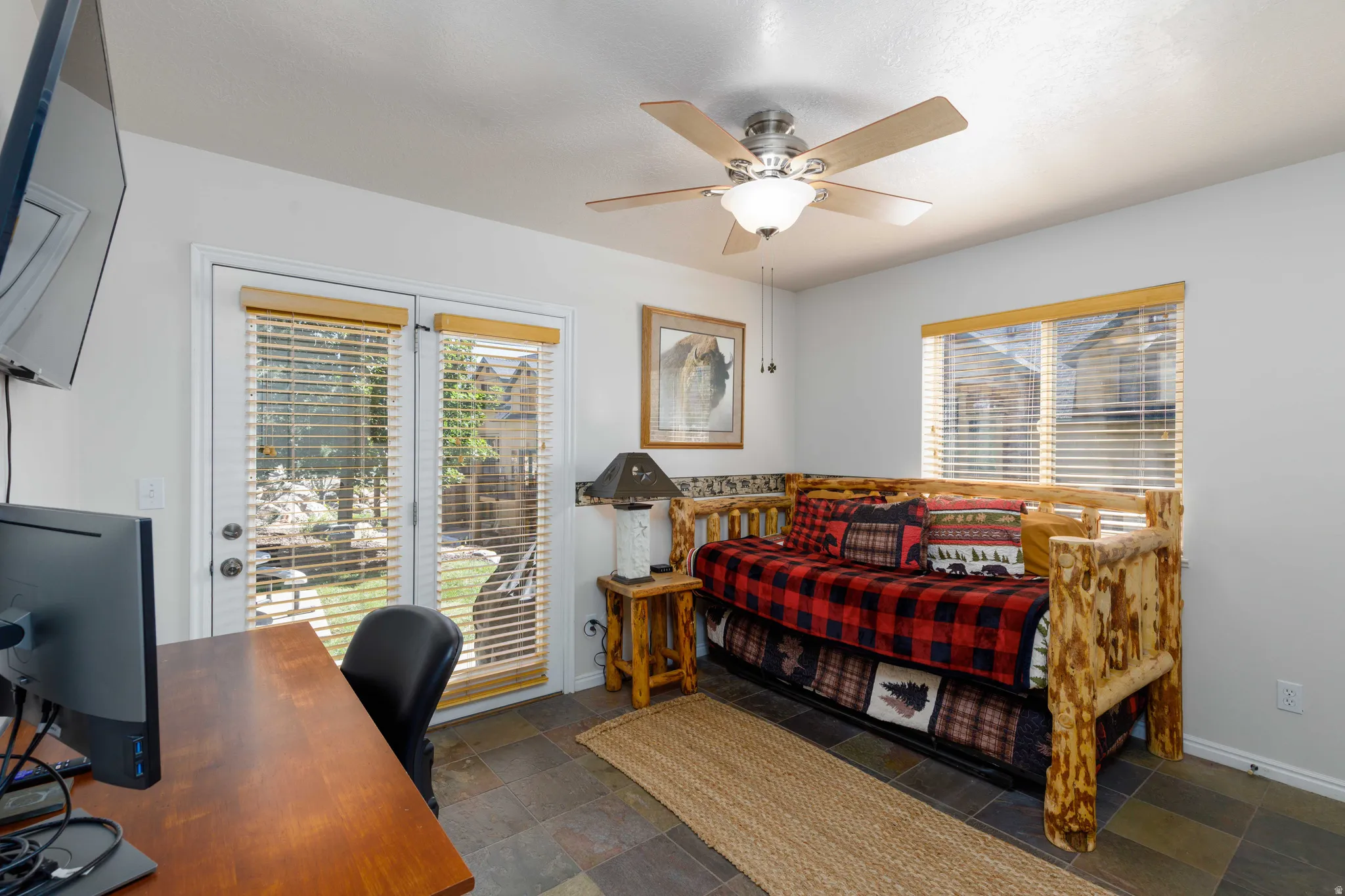 Ceramic tile flooring, white walls, and a ceiling fan with integrated lighting