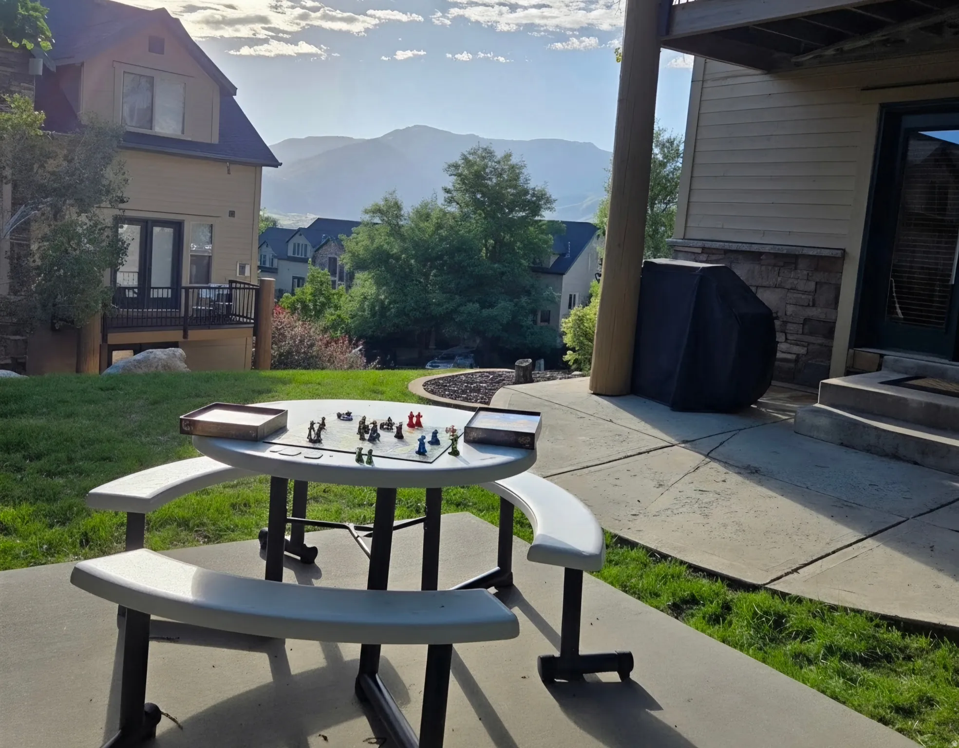Concrete patio with stone veneer wall accents and a tiered design