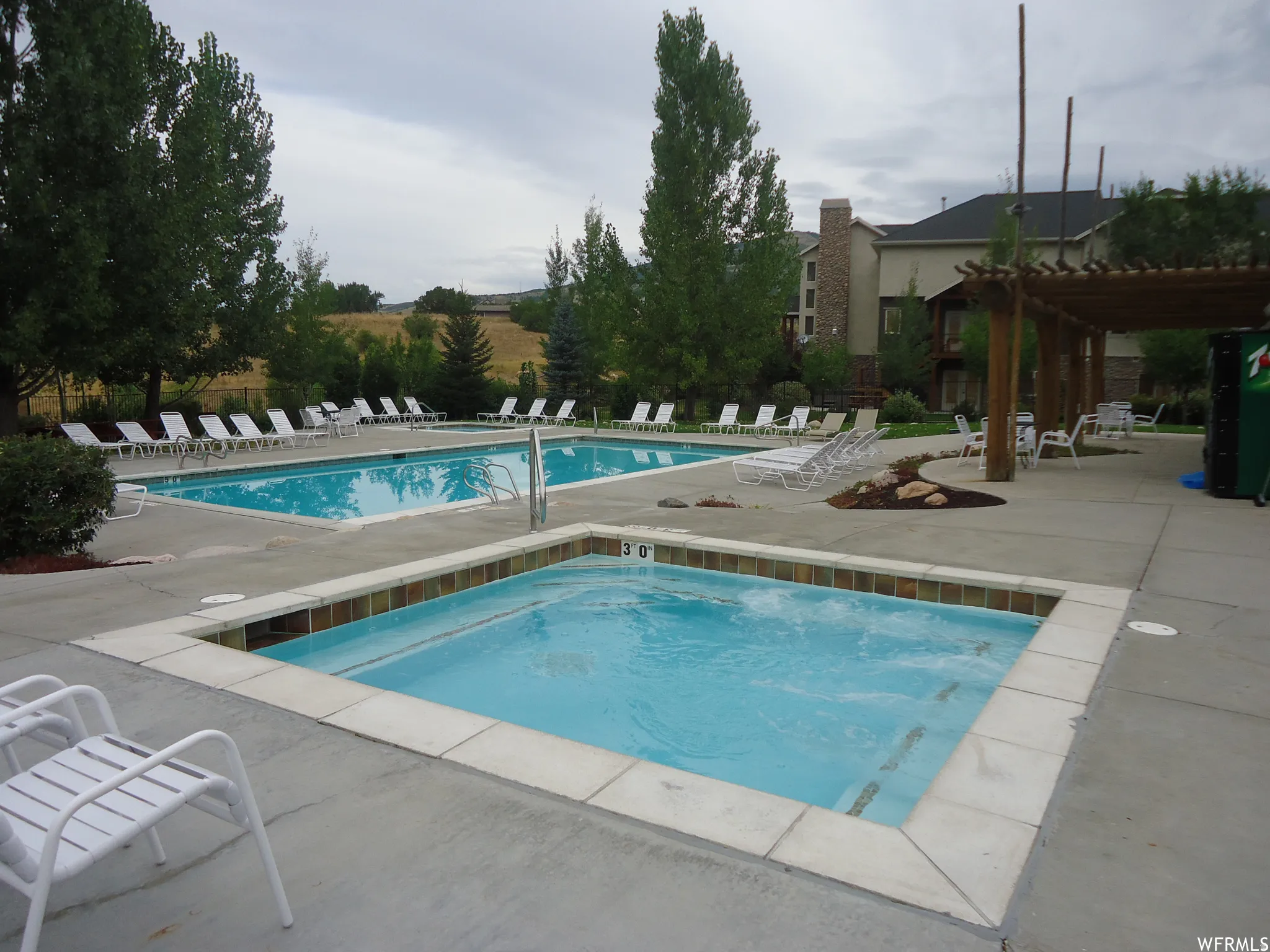 Swimming pool with an adjacent hot tub