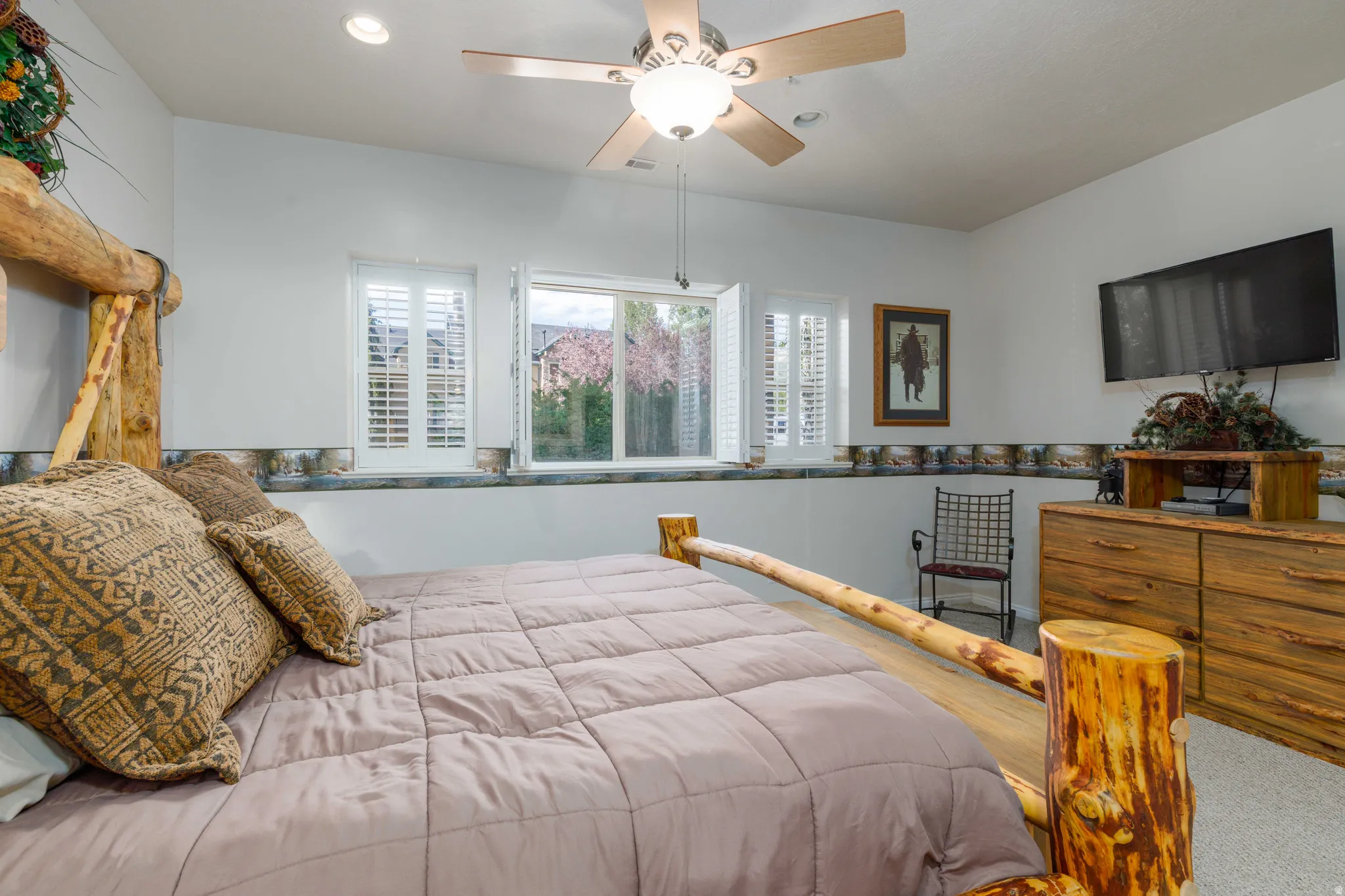 Recessed lighting, ceiling fan, and window with plantation shutters