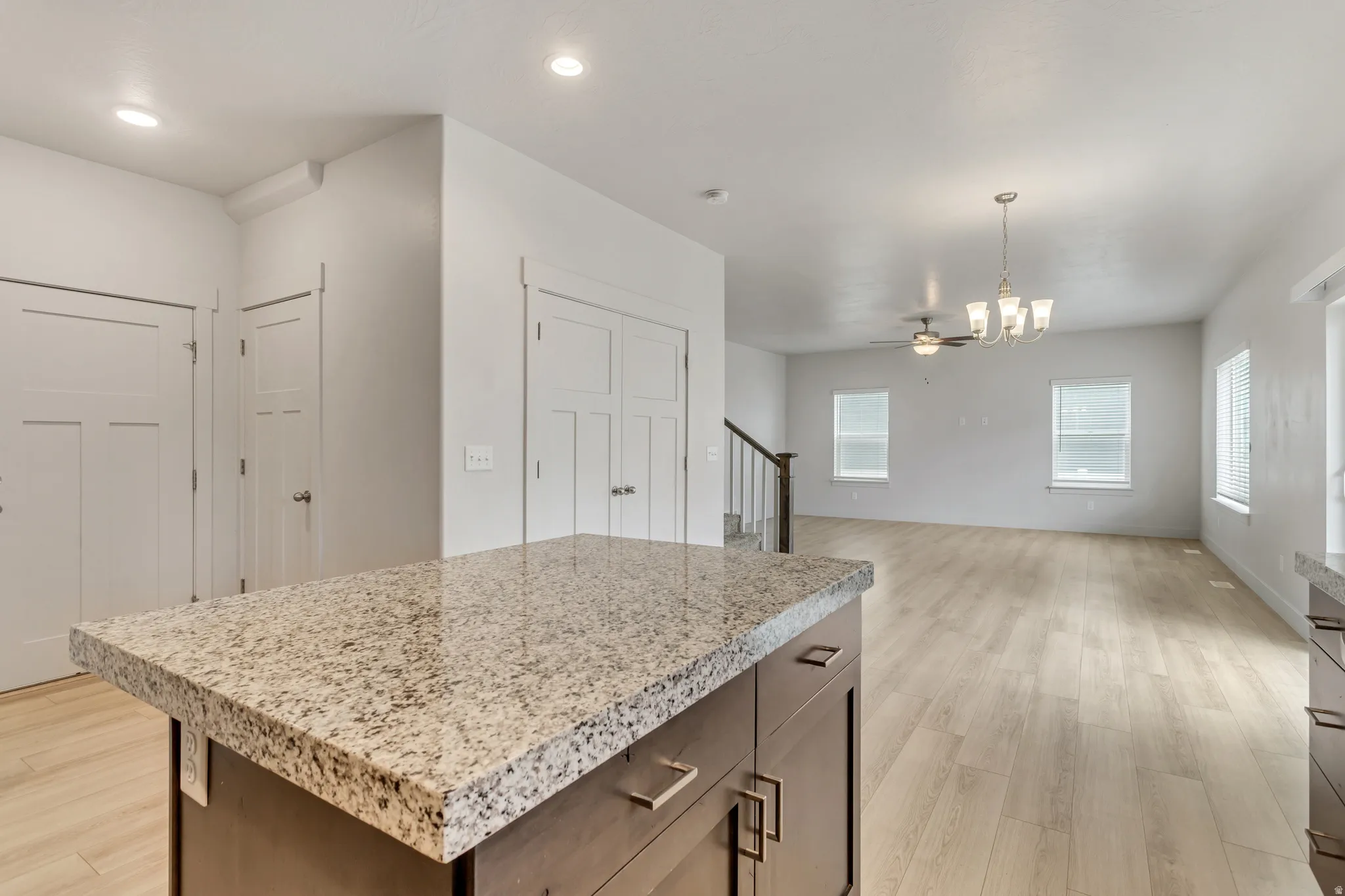 Kitchen island featuring a substantial countertop and built-in cabinetry with modern hardware