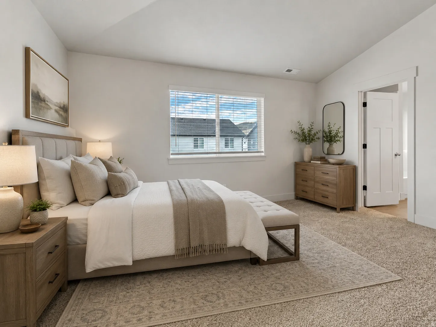 Plush carpet flooring, a large window with blinds, and a solid core door