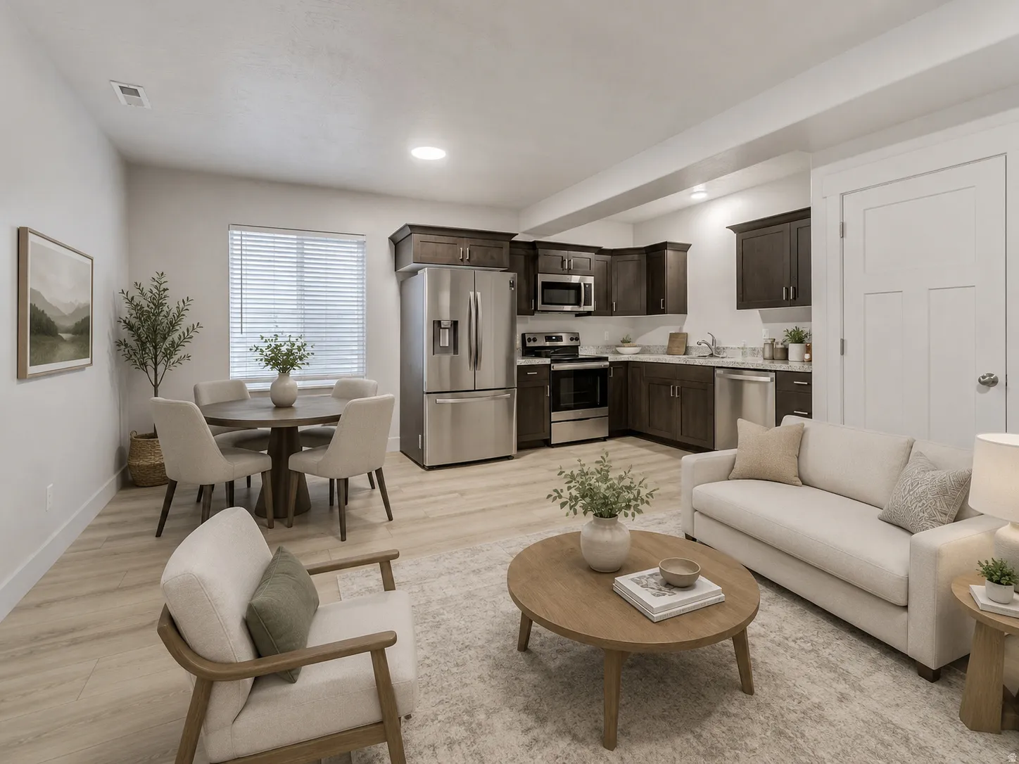 Open-concept living space with wood-finish flooring, recessed lighting, and a kitchen featuring dark wood cabinetry and stainless steel appliances