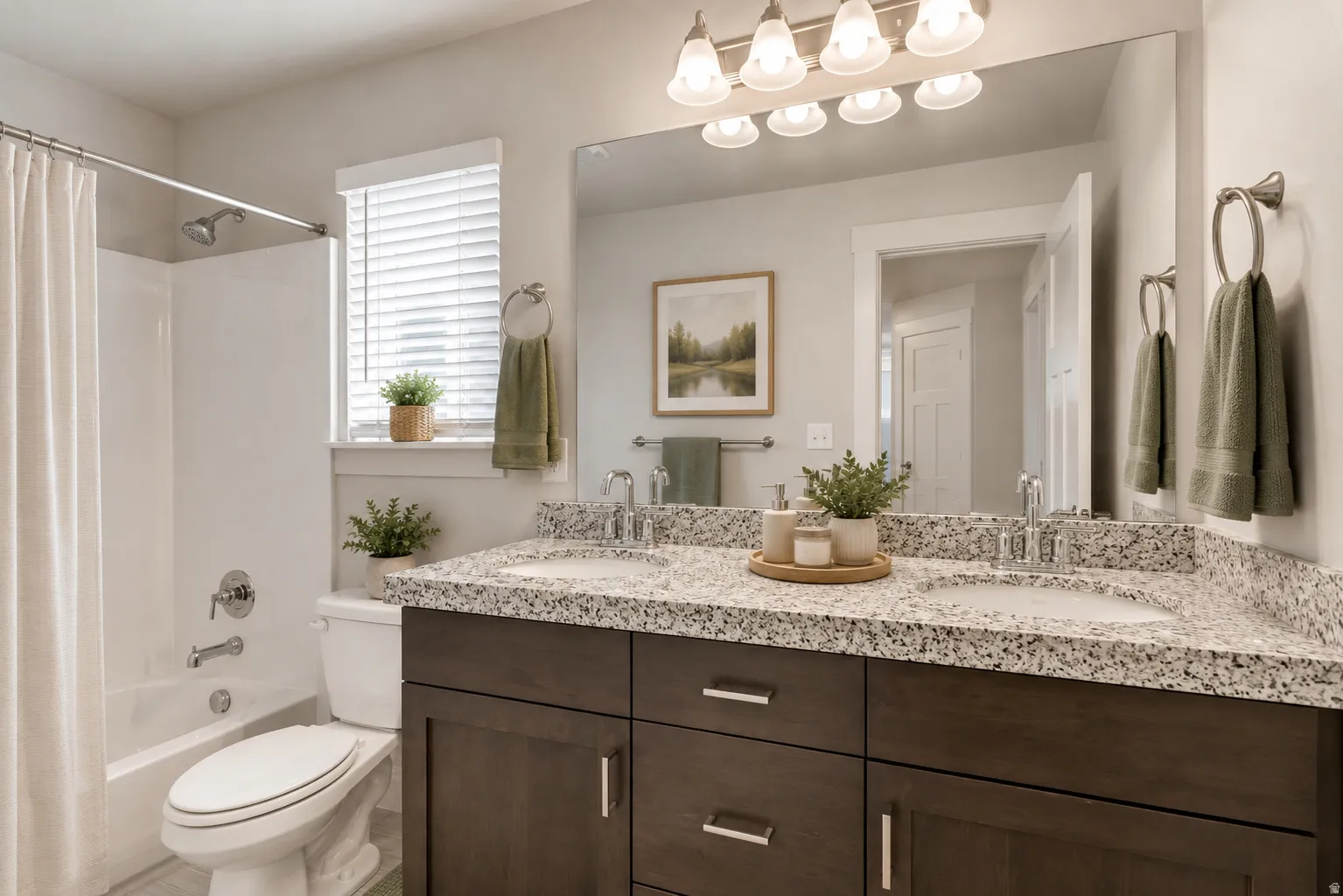 Double vanity with stone-finish countertop, wood-finish cabinetry, and undermount sinks