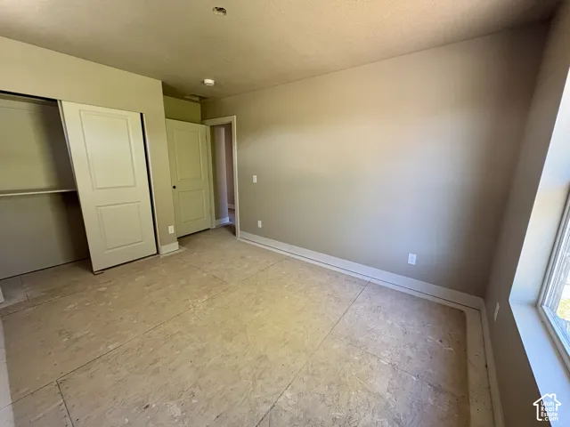 Neutral wall tones, two-panel closet doors, and recessed lighting