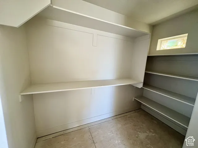 Built-in shelving and storage, with an upper shelf and lower work surface