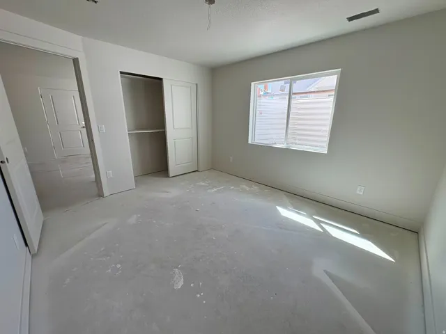 Window offering natural illumination, interior doors, and a built-in closet with shelving