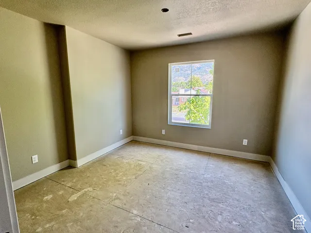 Neutral wall finishes with white trim, recessed ceiling light, and a window providing natural illumination
