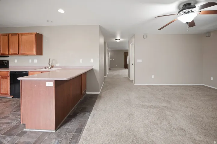 Kitchen featuring wood cabinetry, stainless steel sink, and durable laminate countertops