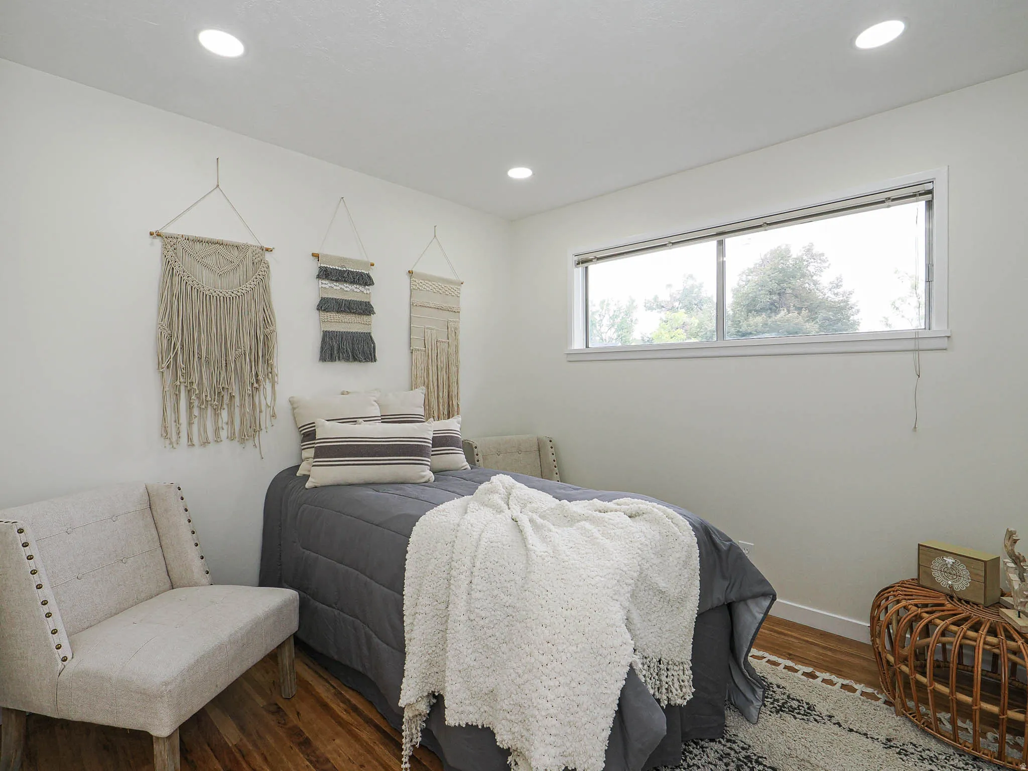 Recessed ceiling lighting, wood-finish flooring, and a horizontal window