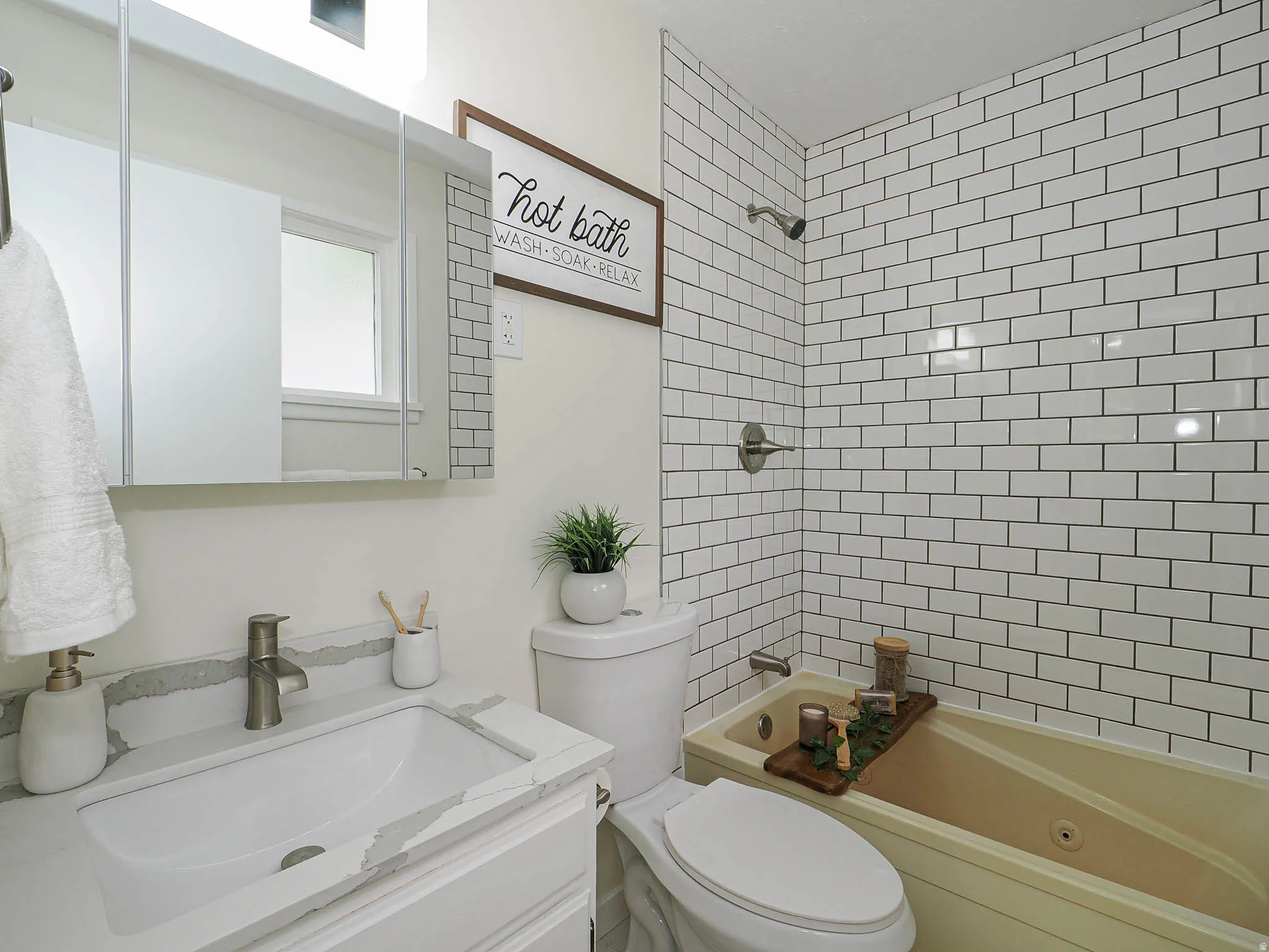 Subway tile shower surround with a built-in bathtub