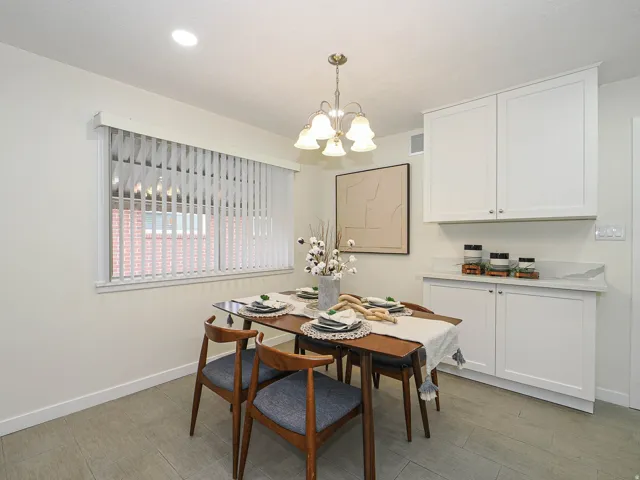Recessed ceiling lighting, white cabinetry, light-toned countertops, and wood-finish flooring
