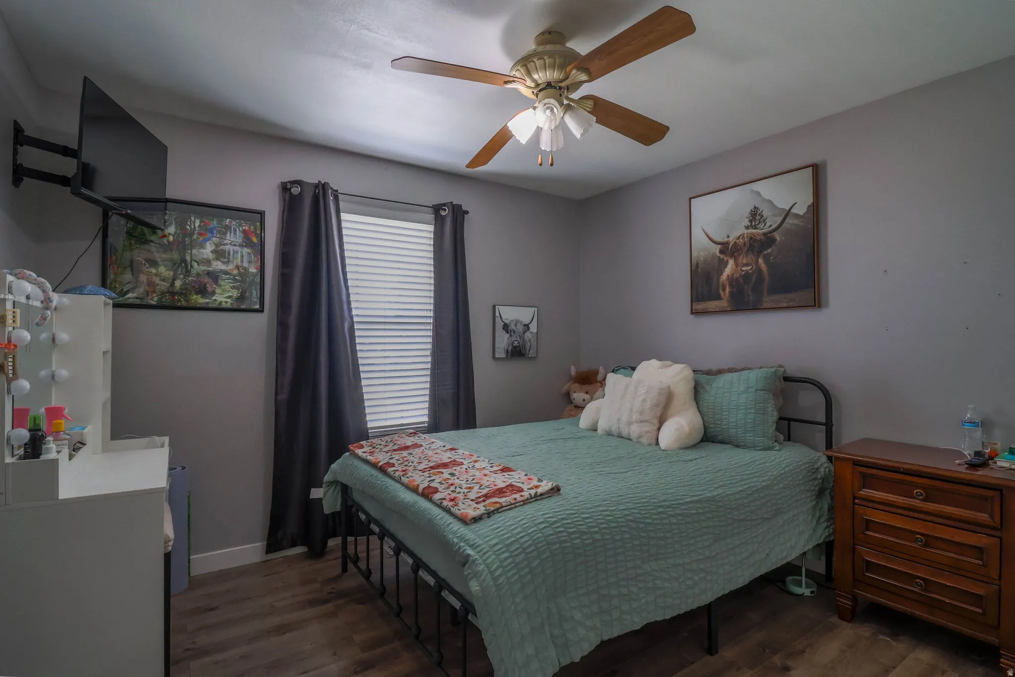 Wood-finish flooring with a ceiling fan light fixture