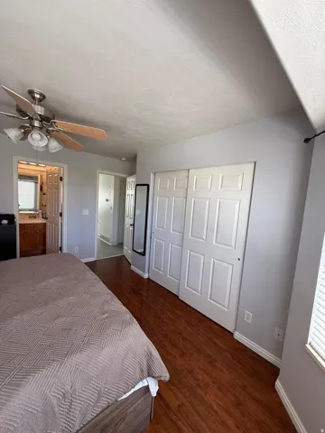 Wood-finish flooring with white baseboards