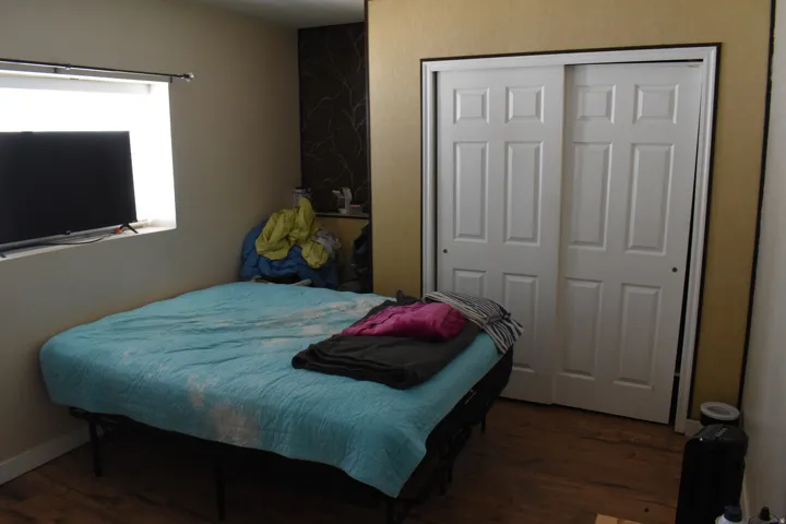 Sliding closet doors, wood-finish flooring, and a horizontal window