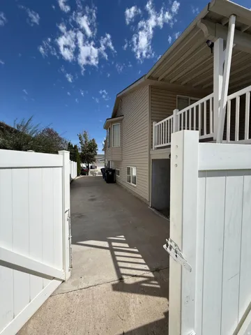Exterior siding with an upper-level covered deck featuring white railings