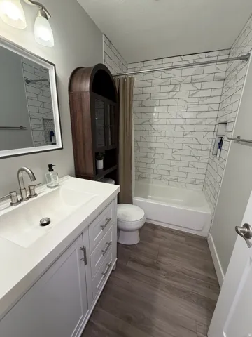 White vanity with an integrated rectangular sink and brushed nickel hardware