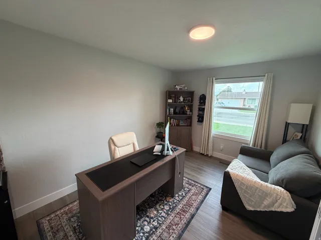 Recessed lighting, wood-finish flooring, and a built-in shelving unit