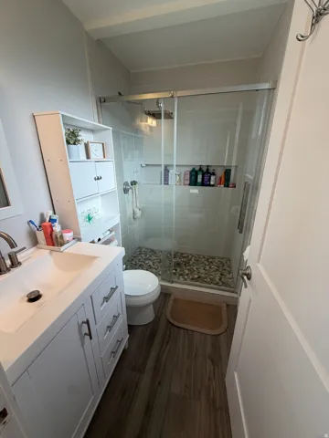 White vanity with brushed nickel hardware, integrated sink, and coordinating faucet