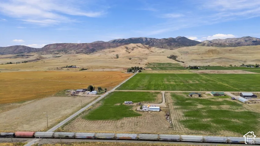 Expansive agricultural land featuring cultivated fields and a distant mountain range
