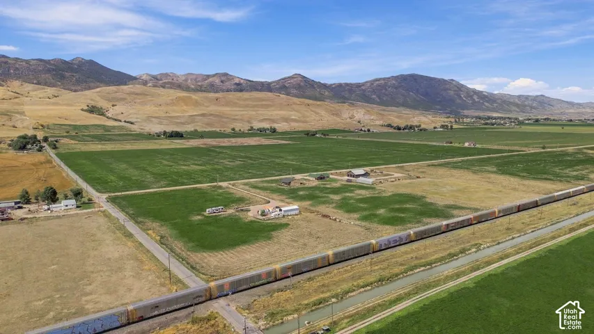 Expansive agricultural land featuring cultivated fields and undeveloped acreage
