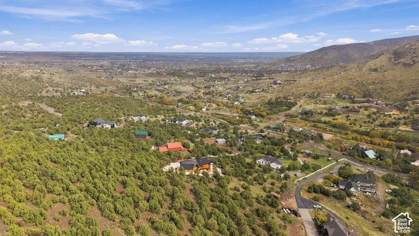 Aerial perspective featuring expansive mountainous terrain, native vegetation, and a panoramic landscape
