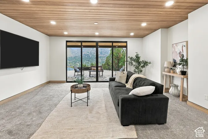 Interior space featuring a wood-plank ceiling, recessed lighting, and expansive floor-to-ceiling glass sliding doors