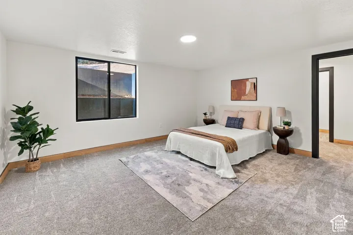 Neutral interior featuring wall-to-wall carpeting, a recessed ceiling light, and a window with a black frame