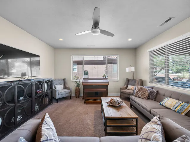 Plush carpet flooring, recessed ceiling lighting, and a modern ceiling fan