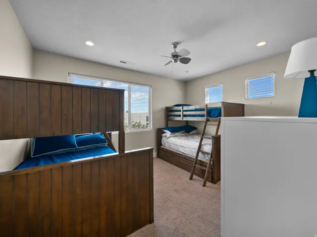 Recessed lighting, ceiling fan, and multiple windows with blinds