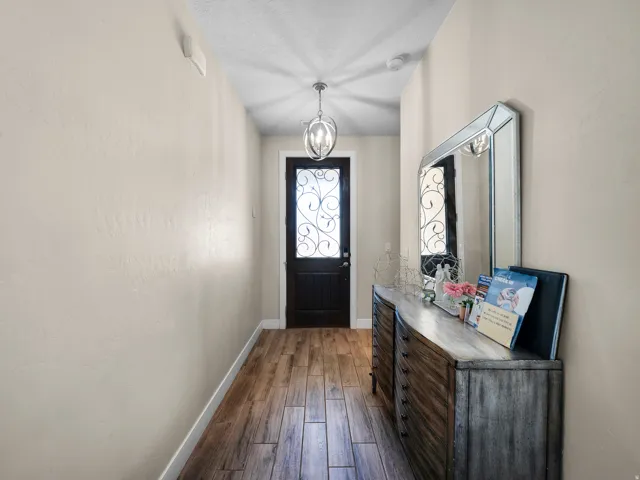 Entryway featuring wood-finish flooring, a decorative glass-paneled entry door, and a semi-flush mount light fixture