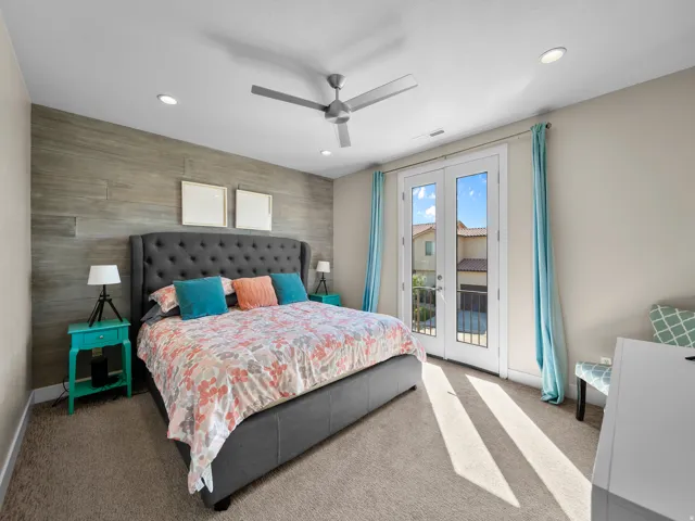 Recessed lighting and ceiling fan above carpeted flooring