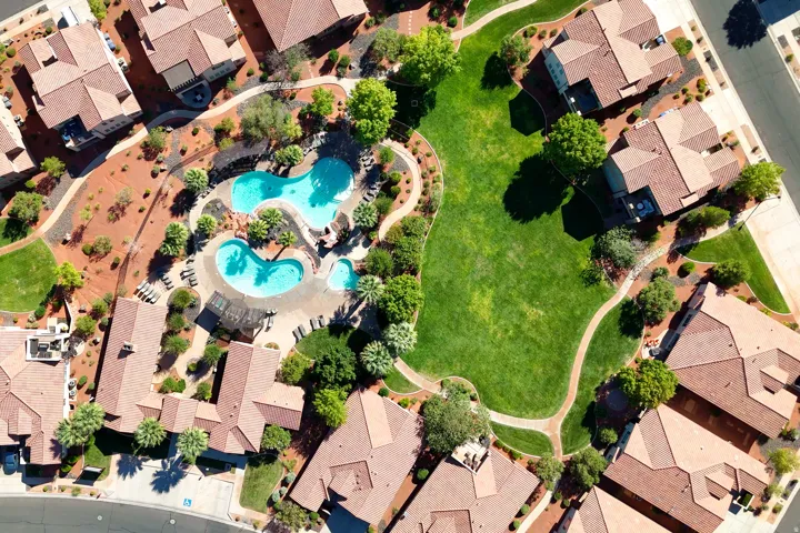 Community features include multiple swimming pools, extensive green spaces, mature landscaping, and integrated pedestrian pathways