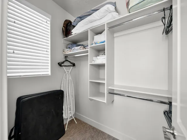 Built-in closet shelving, hanging rods, and integrated drawers