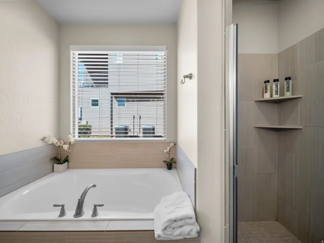 Alcove bathtub with deck-mounted faucet, complemented by horizontal tile detailing