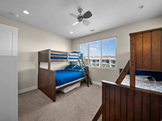 Recessed ceiling lighting, ceiling fan, carpeted flooring, and a large window with blinds