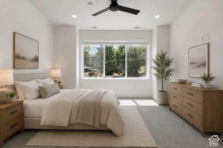 Recessed ceiling lighting, large windows, and a ceiling fan