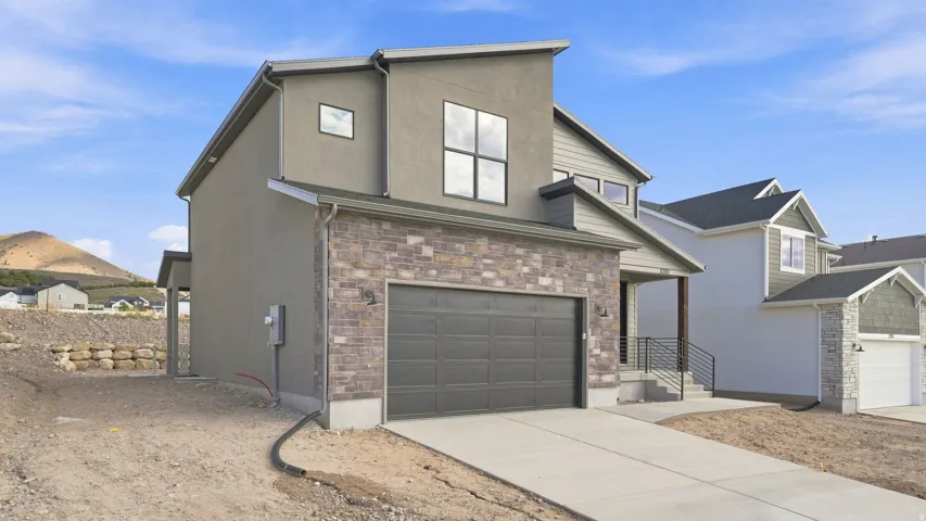 Contemporary exterior with stucco and stone veneer accents