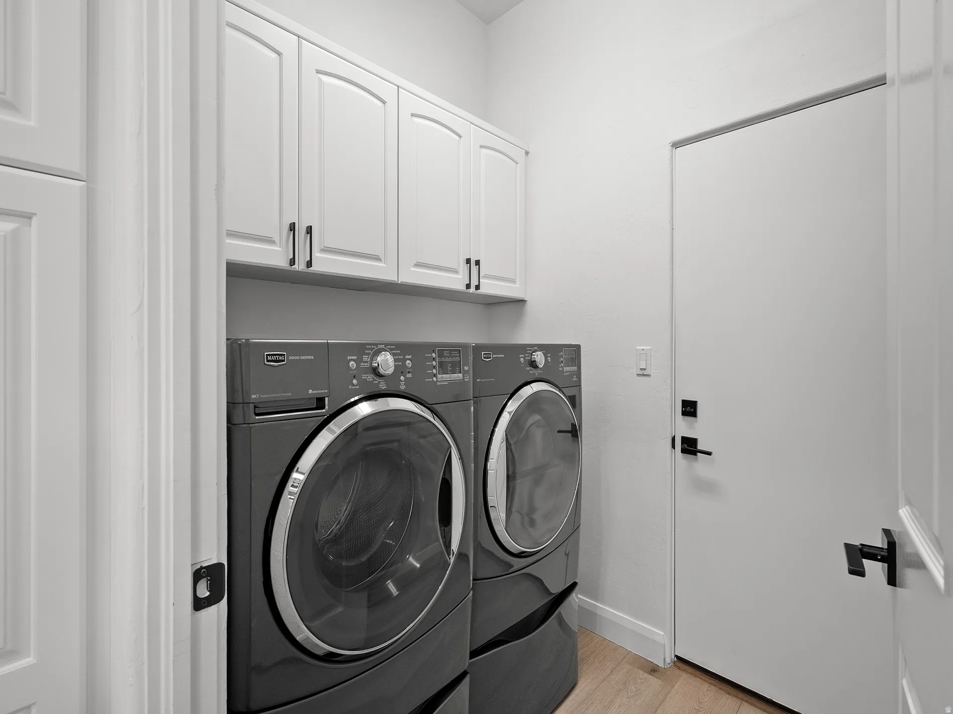 White shaker-style cabinetry with dark hardware