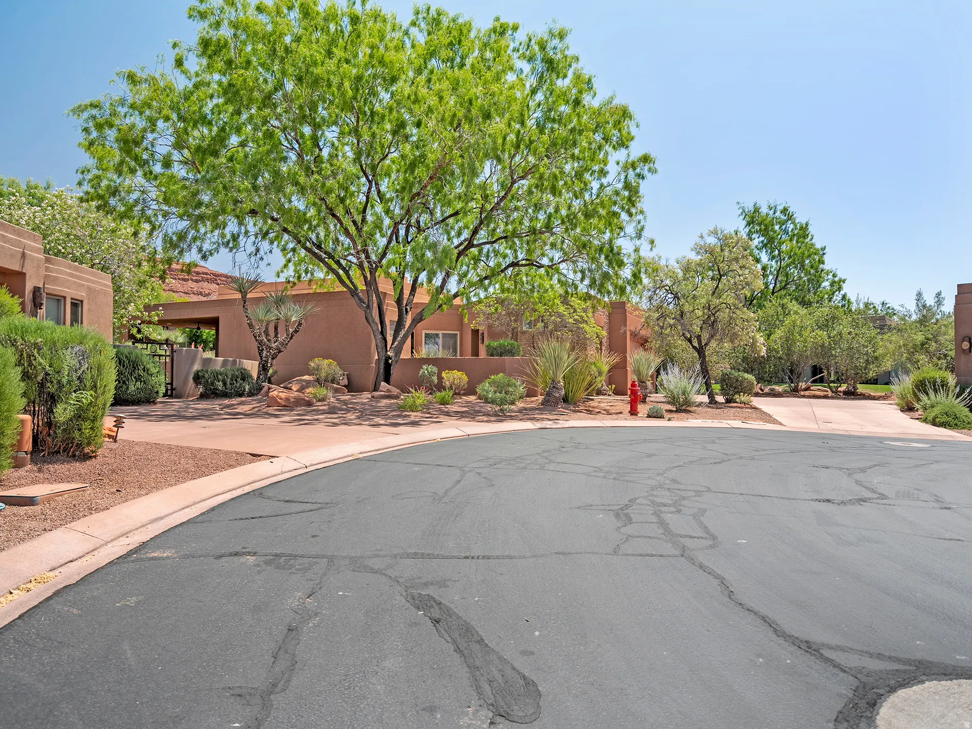 Southwestern-style exterior with stucco finish and prominent landscaping