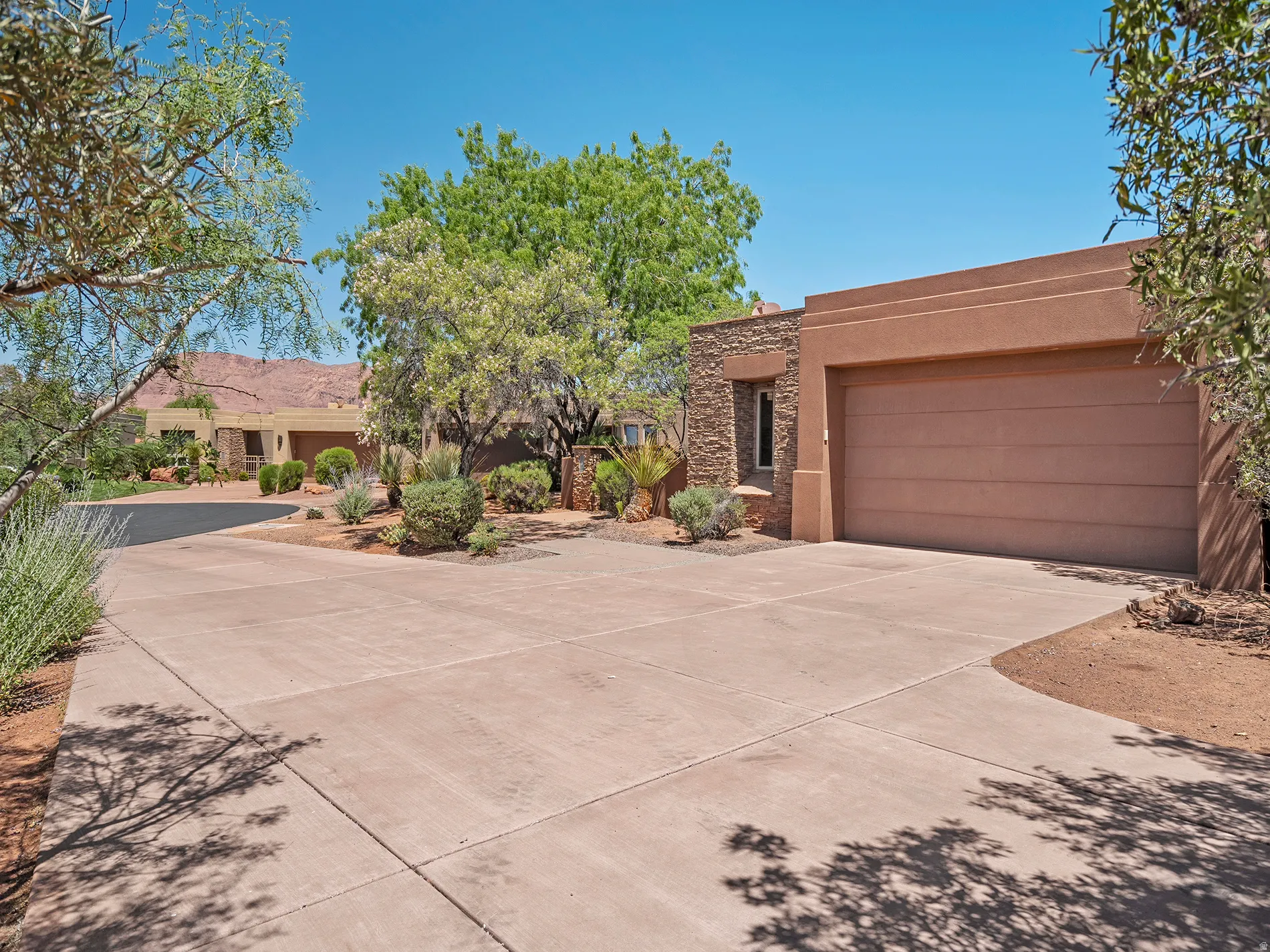 Concrete driveway leading to a built-in garage with a segmented door