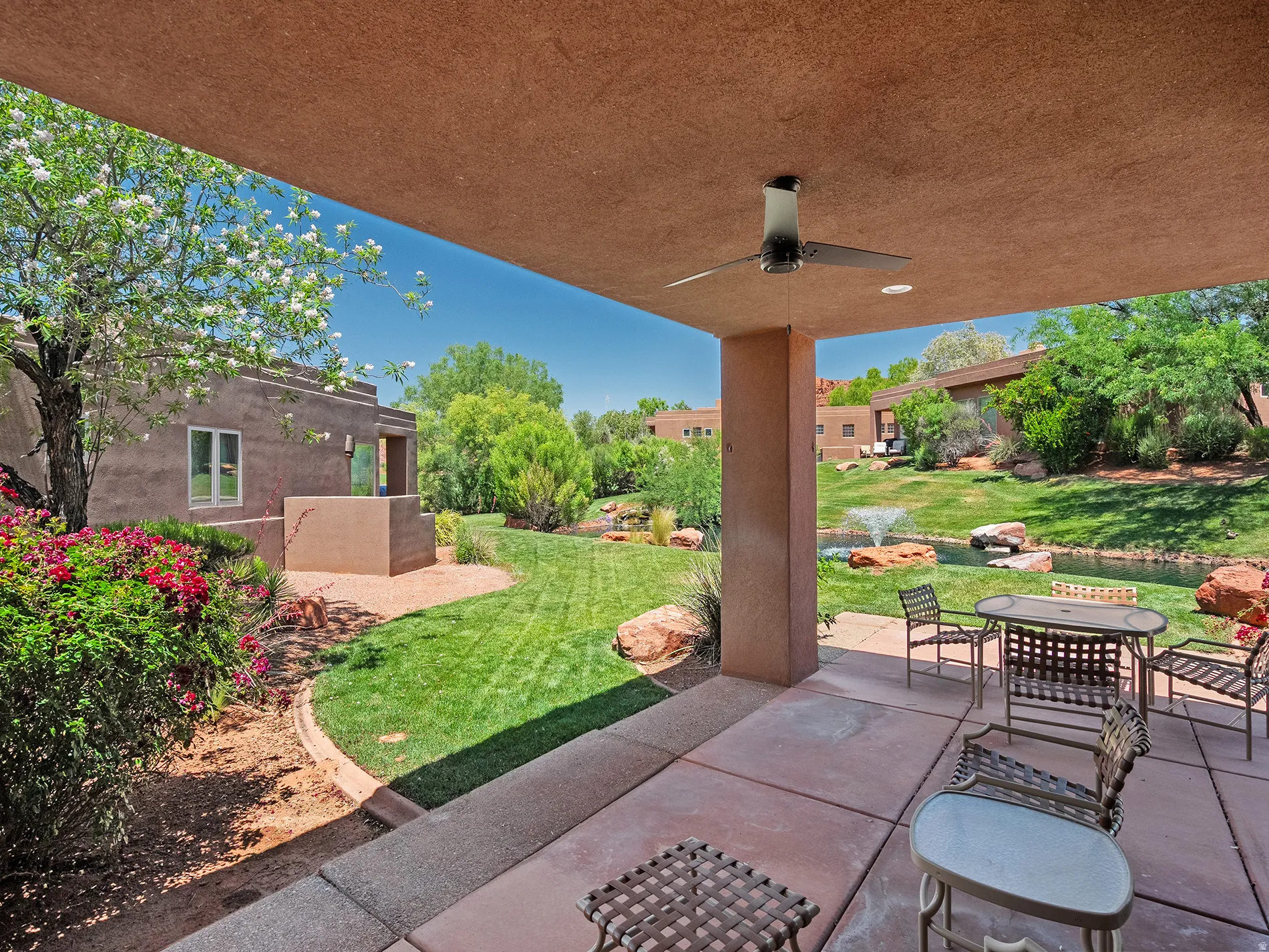 Covered patio with an outdoor ceiling fan, concrete flooring, and recessed lighting