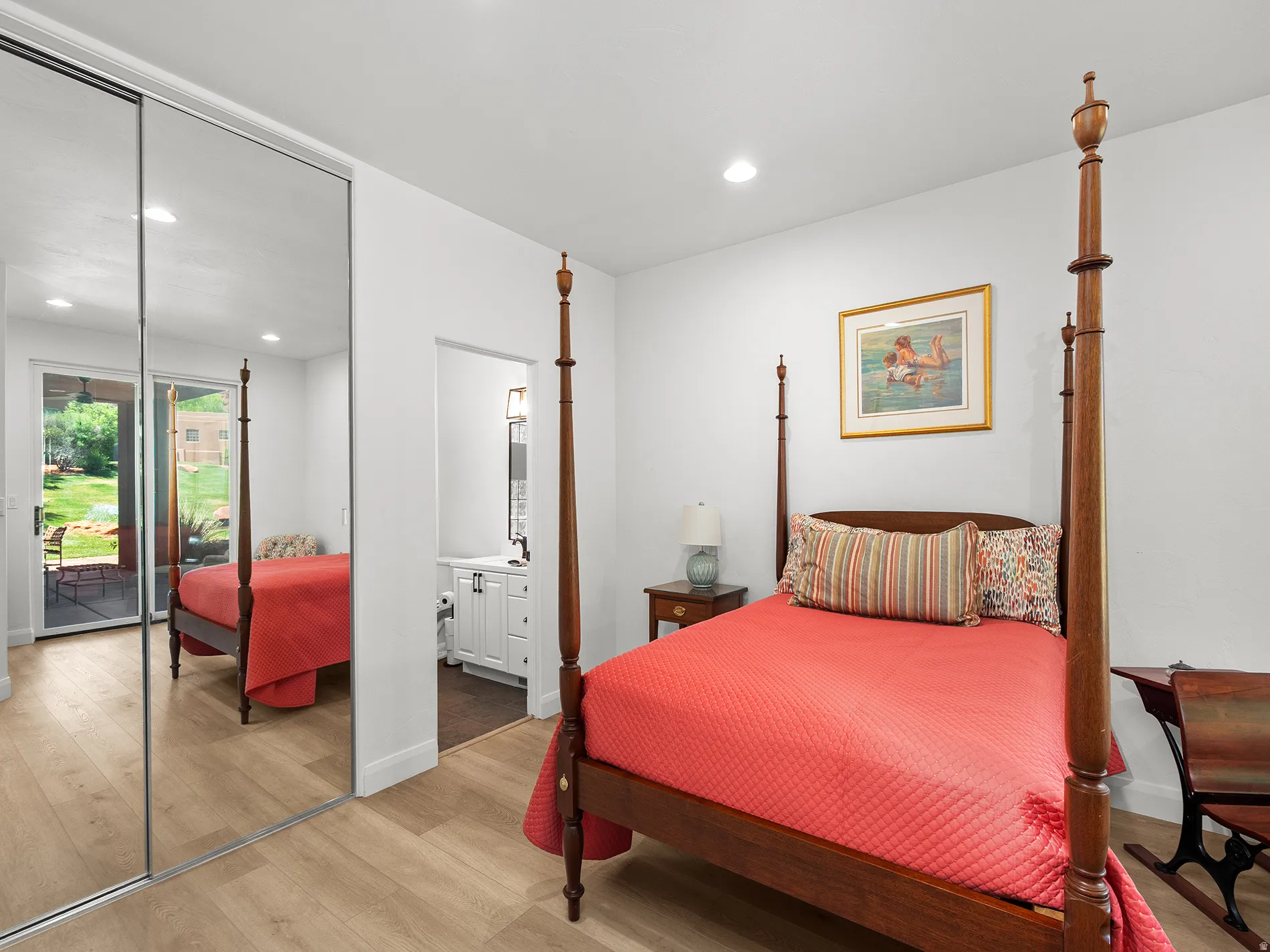 Mirrored closet doors, wood-finish flooring, recessed lighting, and a sliding glass door to exterior
